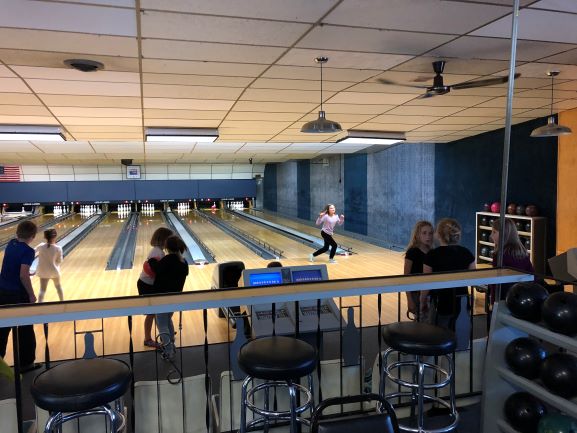 Students bowling during after school adventure club.